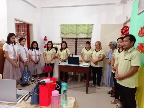 Young people and sisters gathered indoors