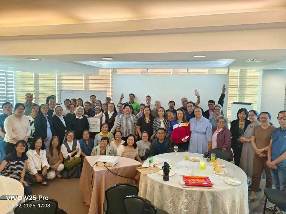 A large group of sisters and fellow participants gathered indoors