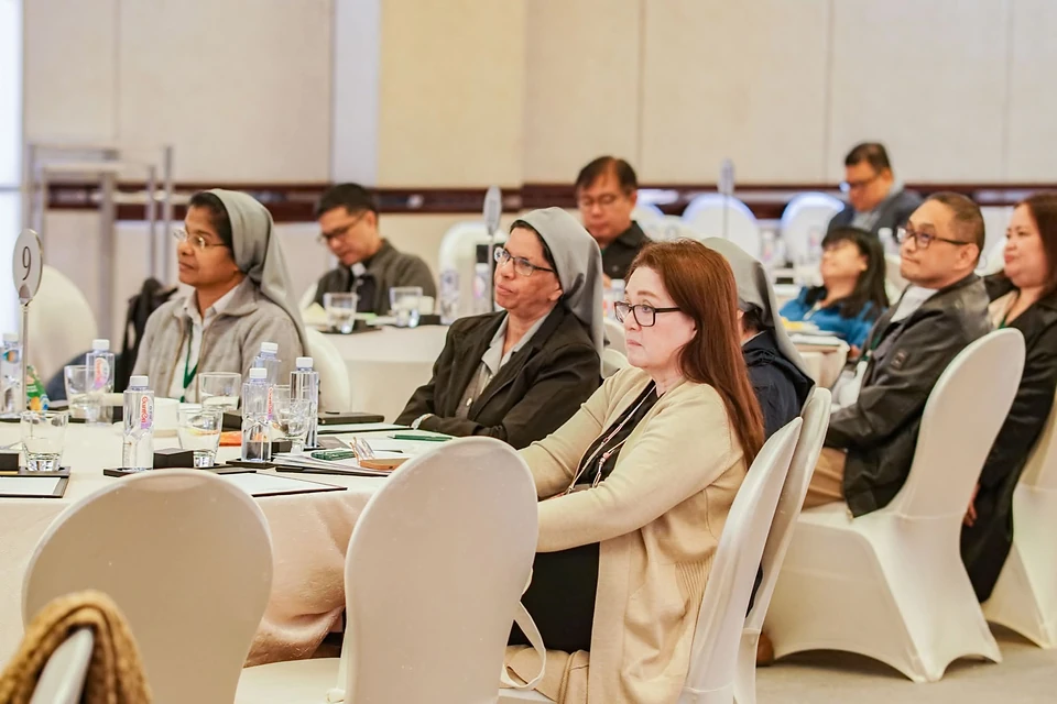 Sisters and fellow participants listening during a meeting