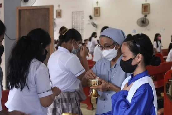 A sister alongside parishioners during a church celebration