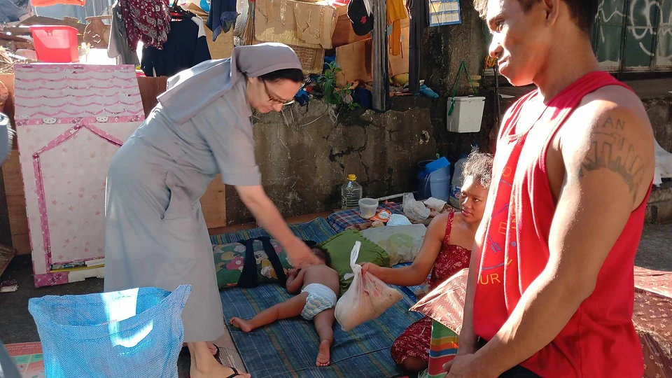 A sister visiting and assisting a community member