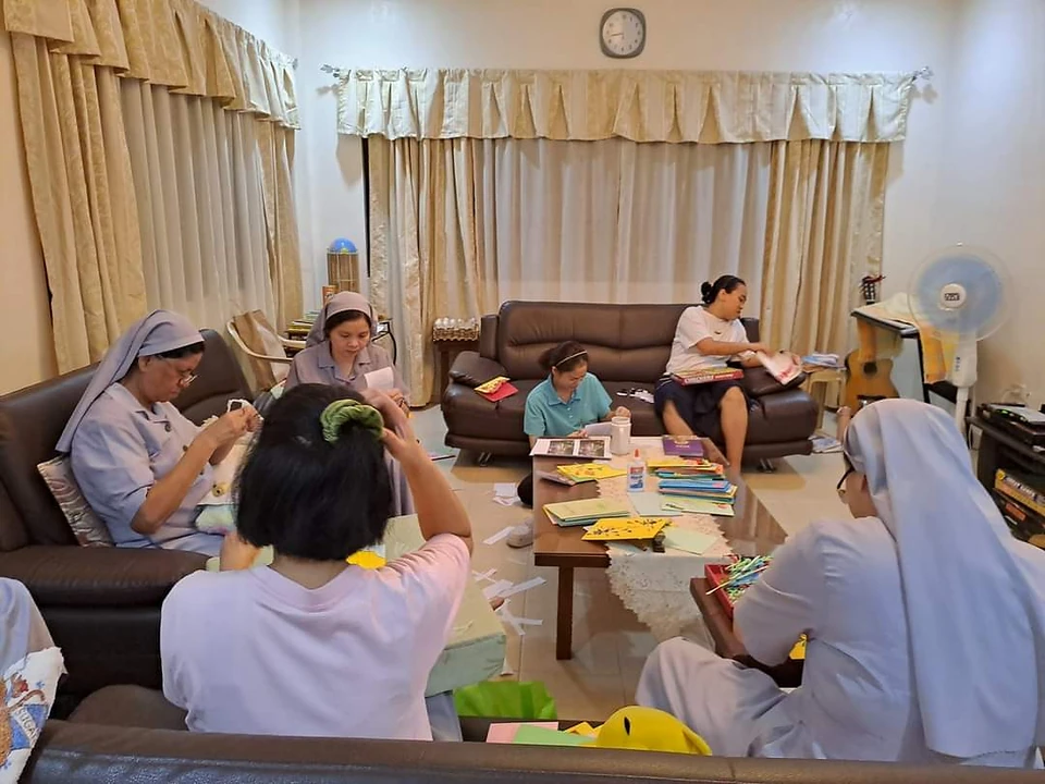 Sisters and community members sharing time around a table