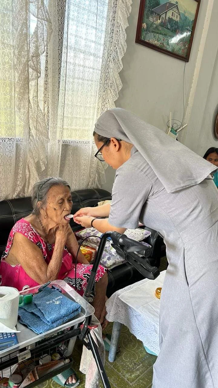 A sister visiting a person resting at home