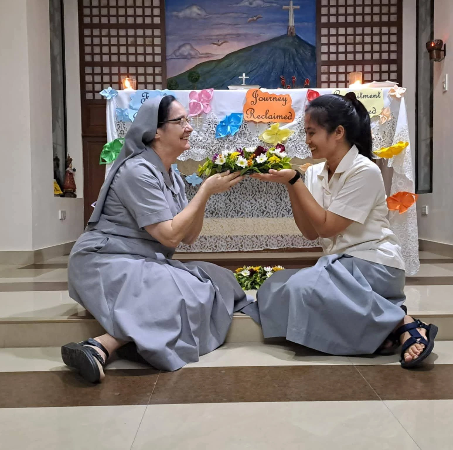 A sister and a young participant sharing a learning activity