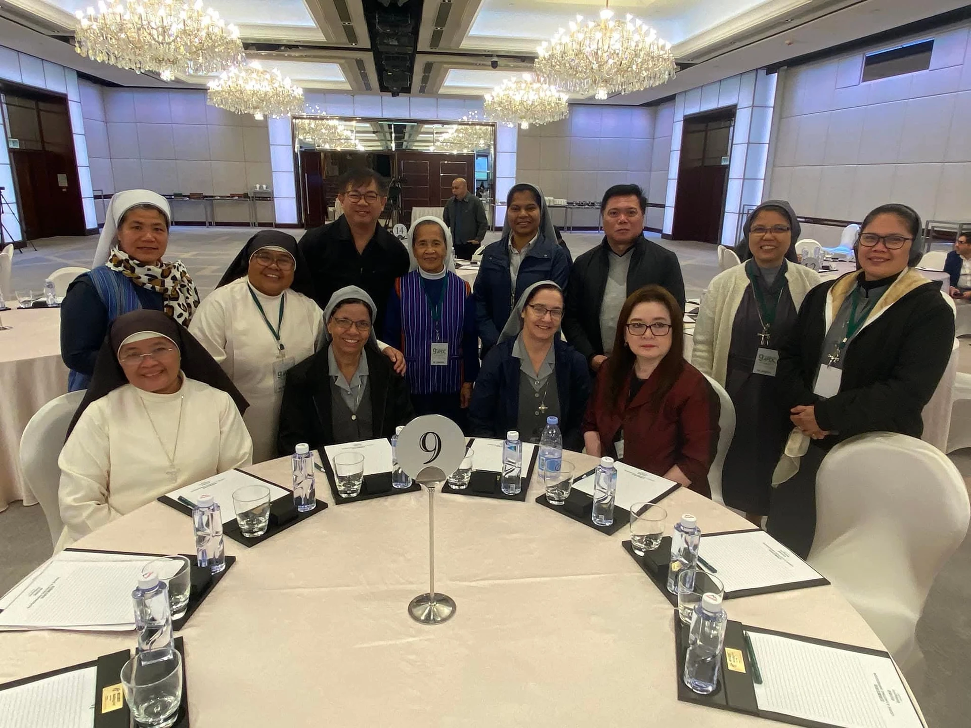 Sisters and fellow participants sharing a table at a gathering